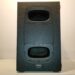 Front view of a black QSC KS Series speaker with two bass ports and a textured finish, placed against a plain white background.