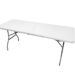 A white folding table with metal legs is fully extended and standing on a white background. The table has a seam in the middle, indicating it can be folded.