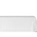 A white rectangular table covered with a smooth, draped cloth against a plain background.