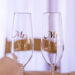 Two champagne flutes on a table, each labeled with Mrs and Mr in elegant script, set the scene for a wedding videography shoot. The background features soft, blurred tones, capturing a romantic and celebratory atmosphere perfect for full day coverage.
